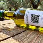 **Italian Food Supply Chain Transparency:**  "A close-up shot of a QR code on a bottle of olive oil, leading to a blockchain-verified traceability record showing the olives being harvested in a sunny Italian grove. Emphasize authenticity and quality."